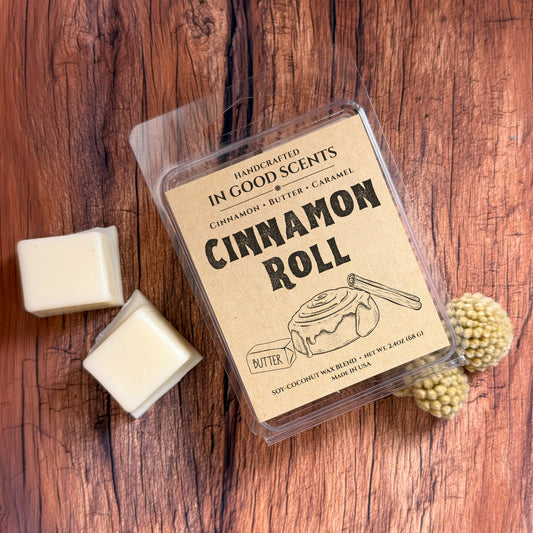 Cinnamon roll-themed wax melt packaging on a wooden surface