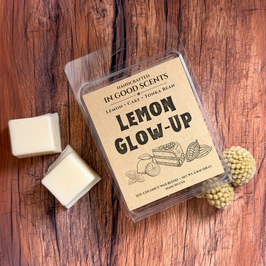 Handcrafted wax melt package labeled 'Lemon Glow-Up' on a wooden surface.
