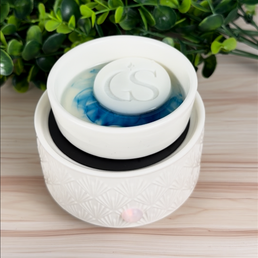 White electric wax warmer with melting wax and In Good Scents GS logo wax melt tart on top