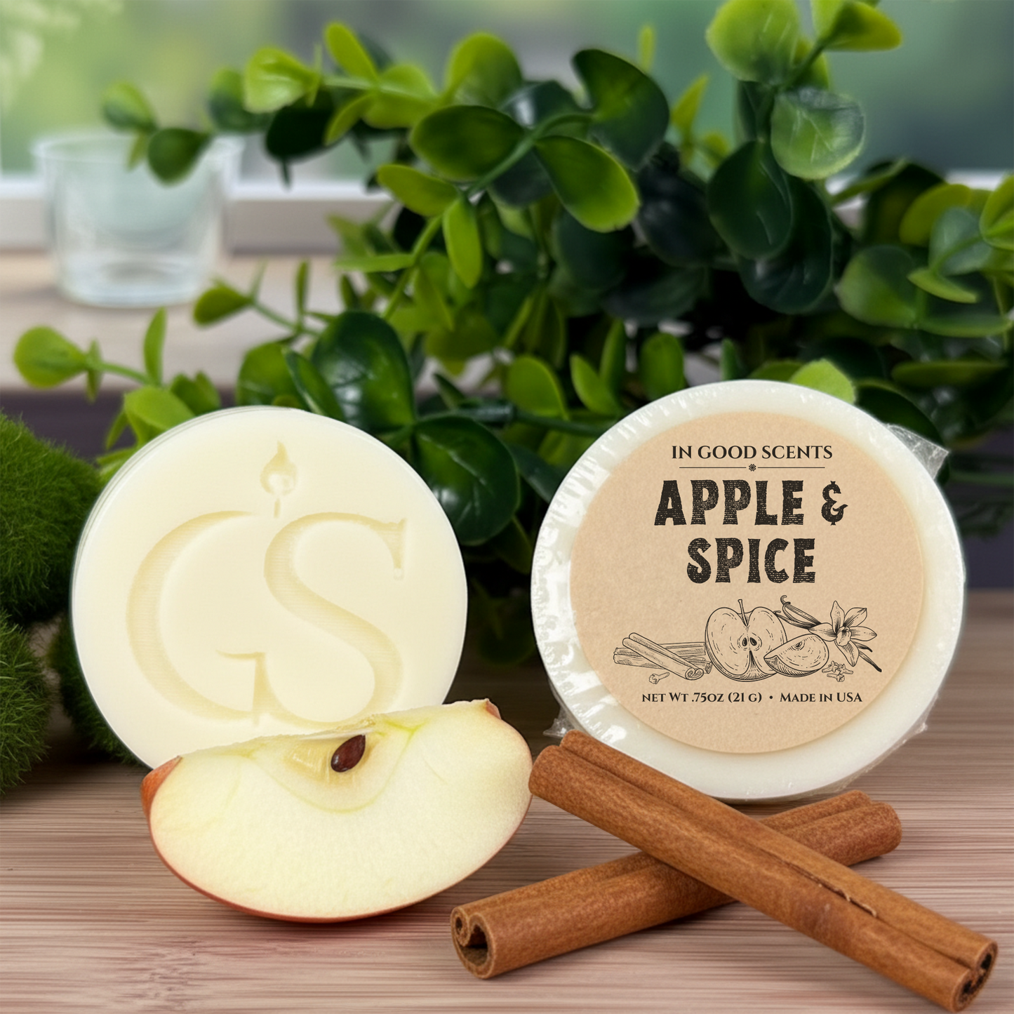 In Good Scents Apple & Spice .75oz wax melt tart with GS logo, labeled round tart beside sliced apple and cinnamon sticks.