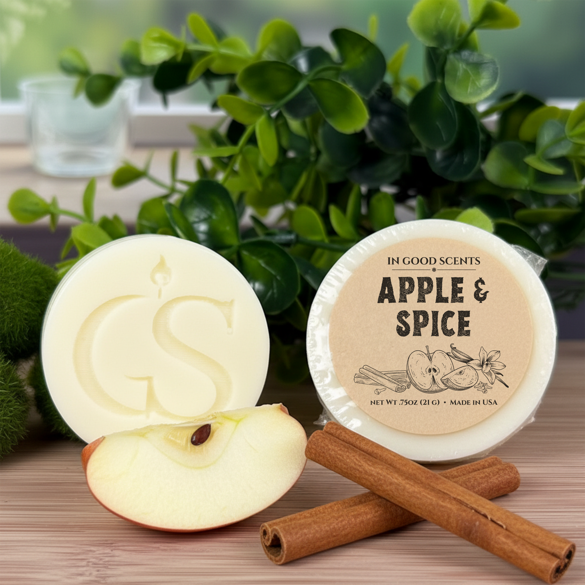 In Good Scents Apple & Spice .75oz wax melt tart with GS logo, labeled round tart beside sliced apple and cinnamon sticks.