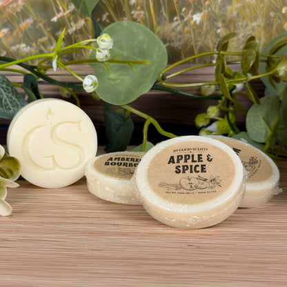 Three wrapped .75oz wax melt tarts styled with greenery; Apple & Spice label in front with GS logo tart beside it.