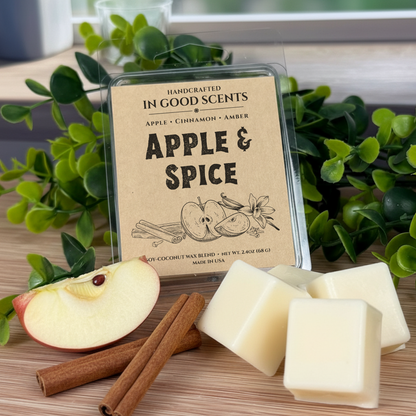 Handcrafted wax melts with 'Apple & Spice' label on a wooden surface with apples and cinnamon sticks.