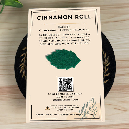 Product Scent Card for 'Cinnamon Roll' with text and QR code on a wooden surface