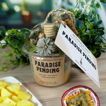 Decorative item with 'Paradise Pending' label on a wooden surface with plants in the background