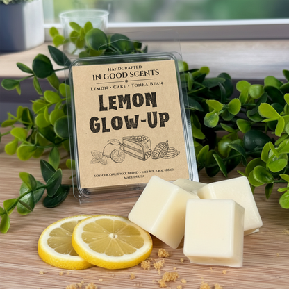 Handcrafted wax melts packaging labeled 'Lemon Glow-Up' with lemon slices and greenery on a wooden surface.