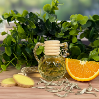Small bottle diffuser of essential oil with a wooden cap, surrounded by green leaves, orange slices, and ginger on a wooden surface.