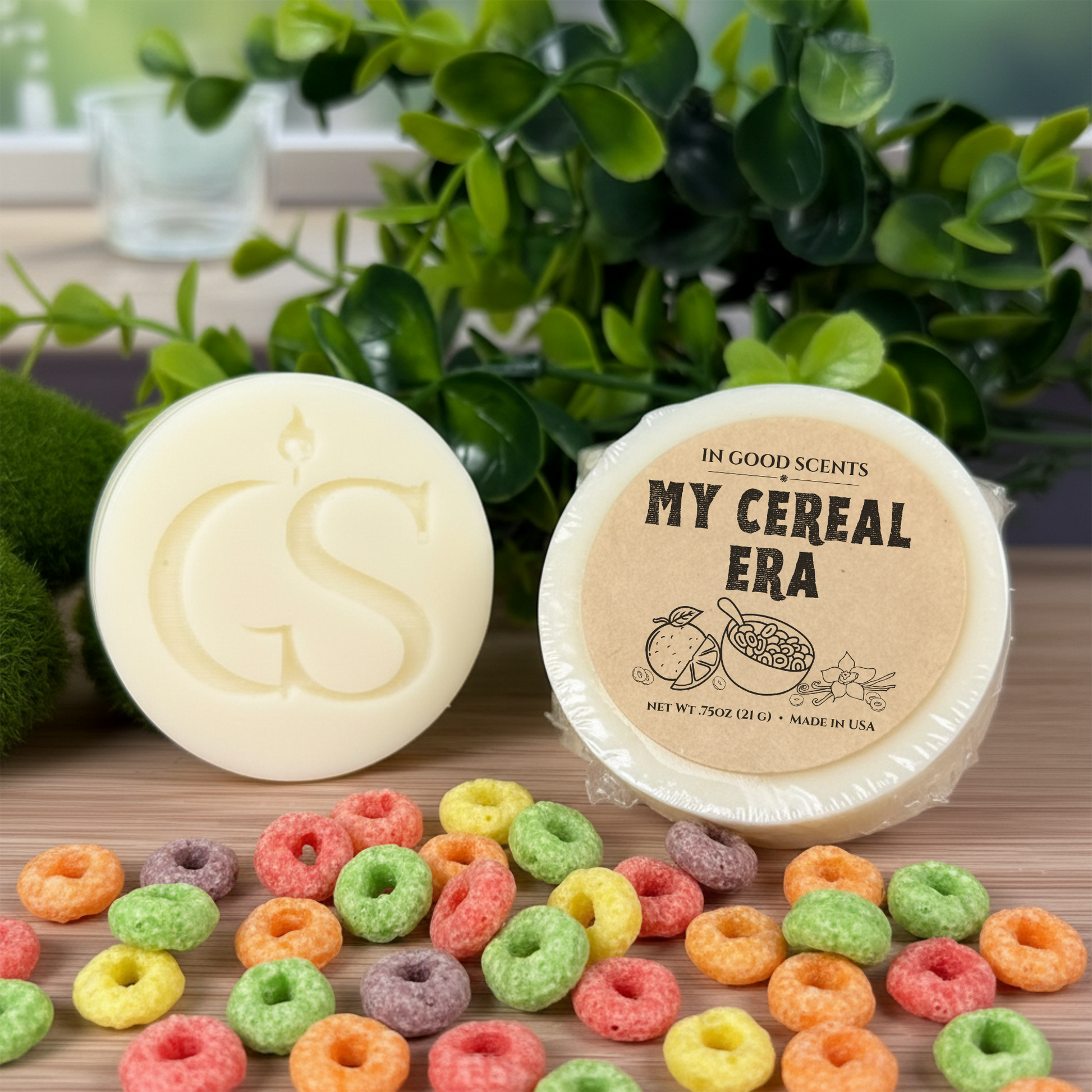 In Good Scents “My Cereal Era” 0.75oz wax melt tart, wrapped with kraft label beside GS wax puck and colorful cereal loops on wood surface.