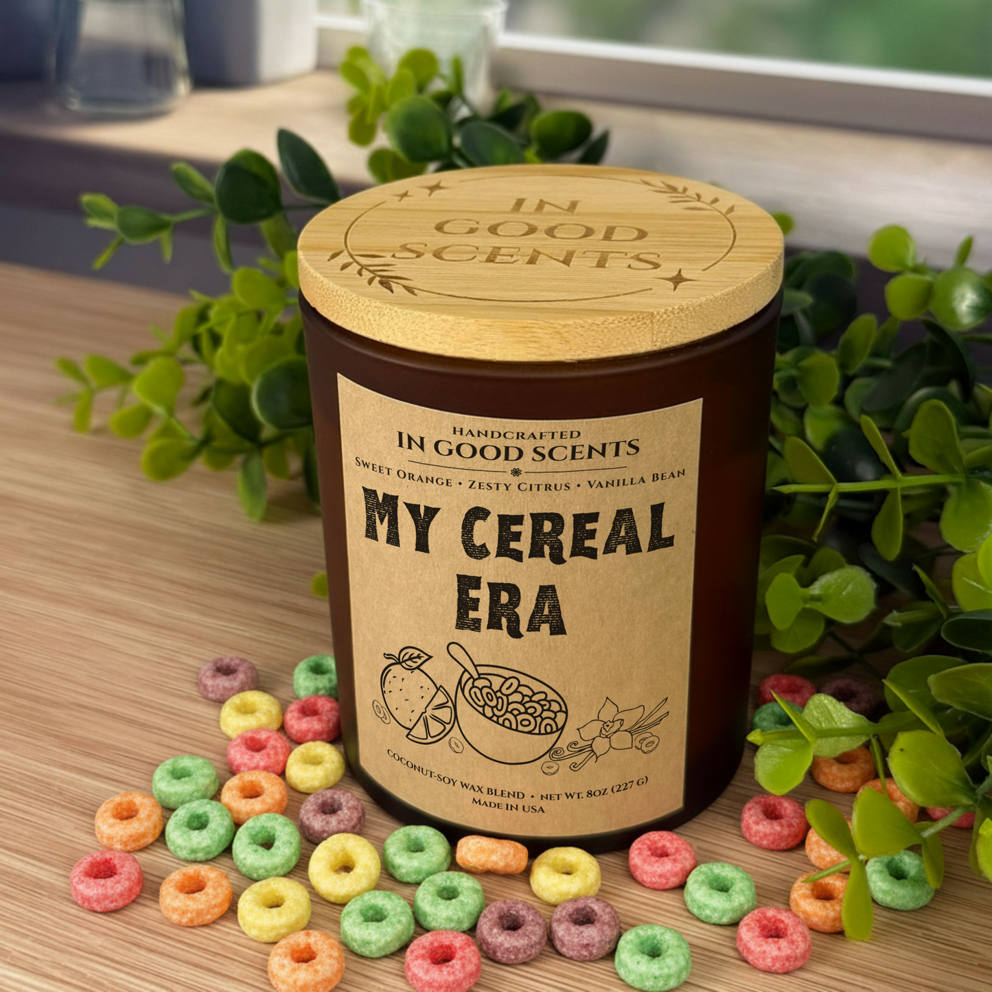 In Good Scents “My Cereal Era” 8oz amber jar candle with bamboo lid, styled with colorful cereal loops on a wood surface.