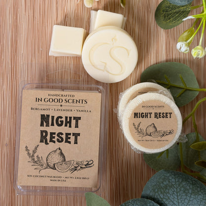 Handcrafted wax melt packaging on a wooden surface with greenery.