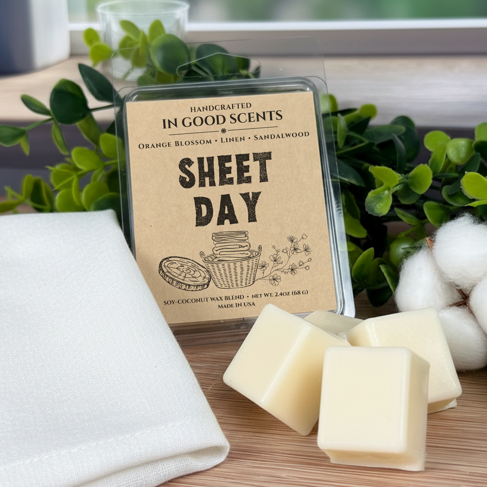 Wax melts with 'Sheet Day' packaging on a wooden surface with plants in the background