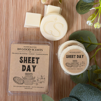 Handcrafted wax melts with 'In Good Scents' branding on a wooden surface.